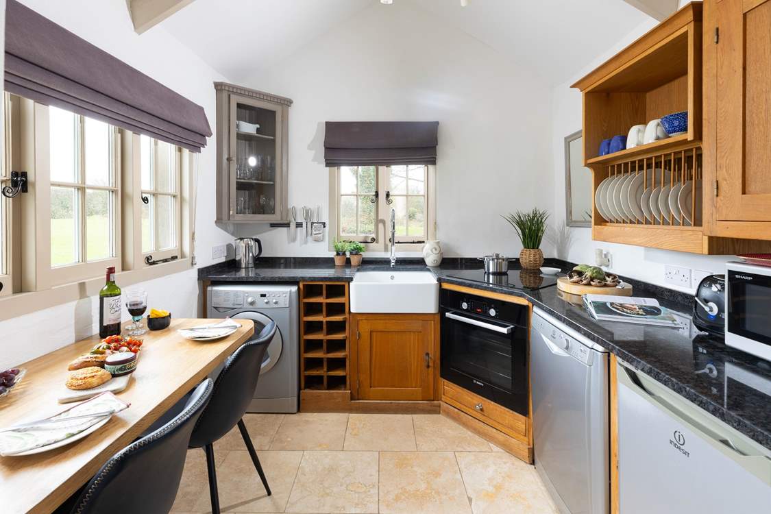 A bespoke kitchen with dining-table overlooking the beautifully kept grounds.