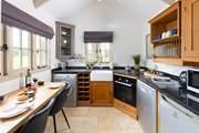 A bespoke kitchen with dining-table overlooking the beautifully kept grounds.