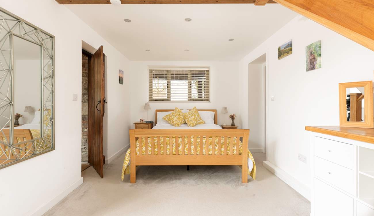 Just off the open plan sitting-room is Bedroom 1 with a large walk-in wardrobe.