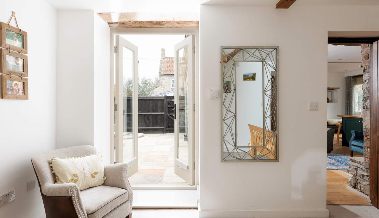 Doors open out from Bedroom 1 to the private courtyard.