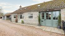 The Smithy is on the left-hand side (with the cream doors) and Minstrels is on the right (green doors). Both properties have a high level of privacy.