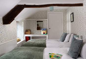 Younger members will adore this twin bedroom with garden views and wide windowsills to sit on.