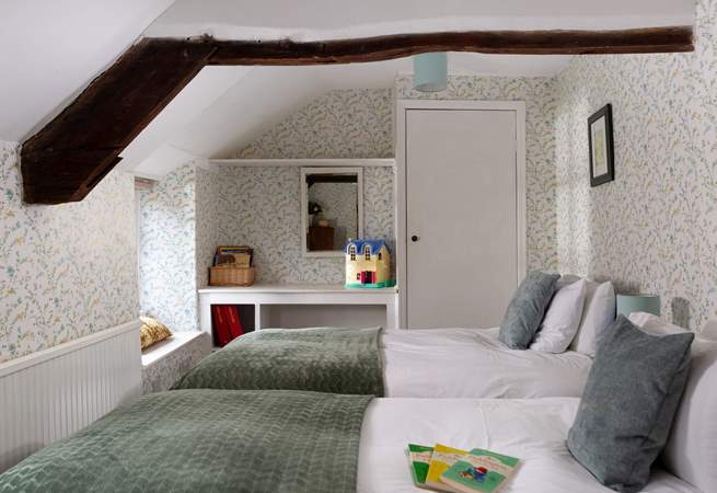 Younger members will adore this twin bedroom with garden views and wide windowsills to sit on.