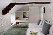 Younger members will adore this twin bedroom with garden views and wide windowsills to sit on.