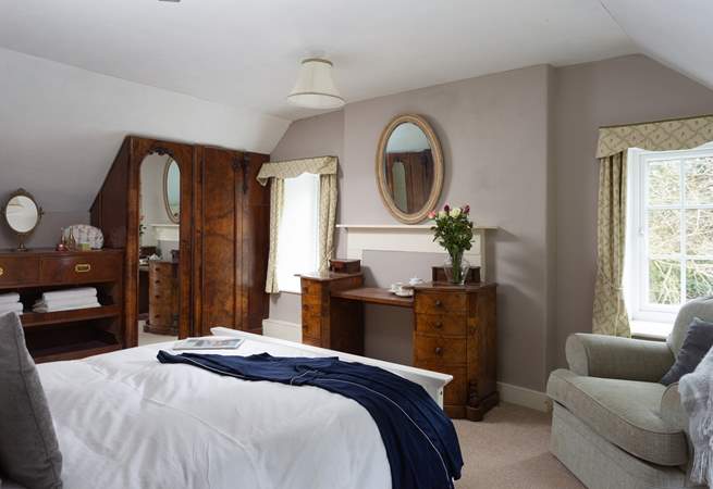 There are beautiful views of the garden from this bedroom.
