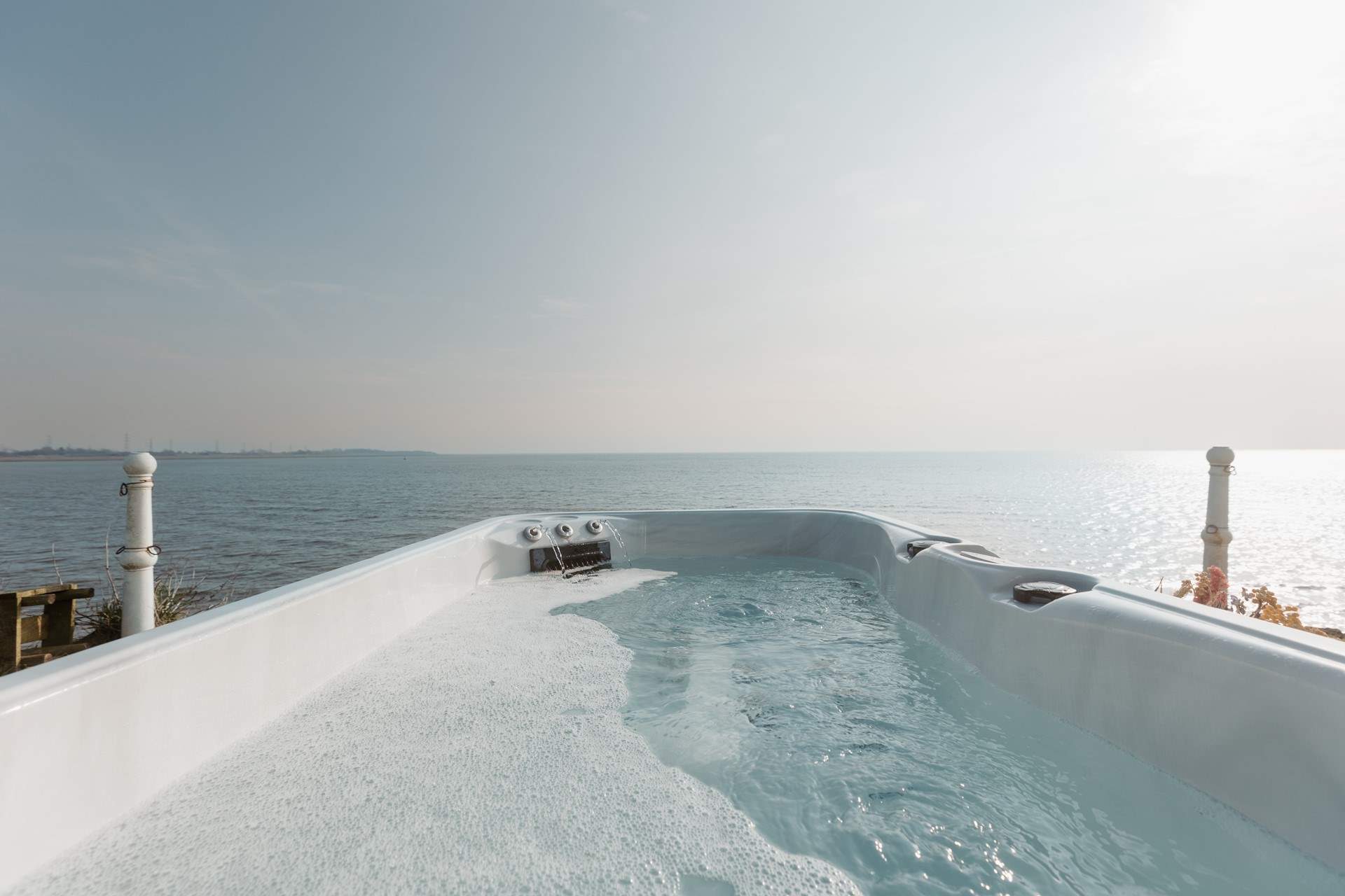Unwind in the bubbling hot tub, overlooking the ocean.