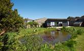 The garden cabin is situated in the grounds next to an organic pond. This is the perfect spot to watch the sun go down with a glass of bubbles. - Thumbnail Image