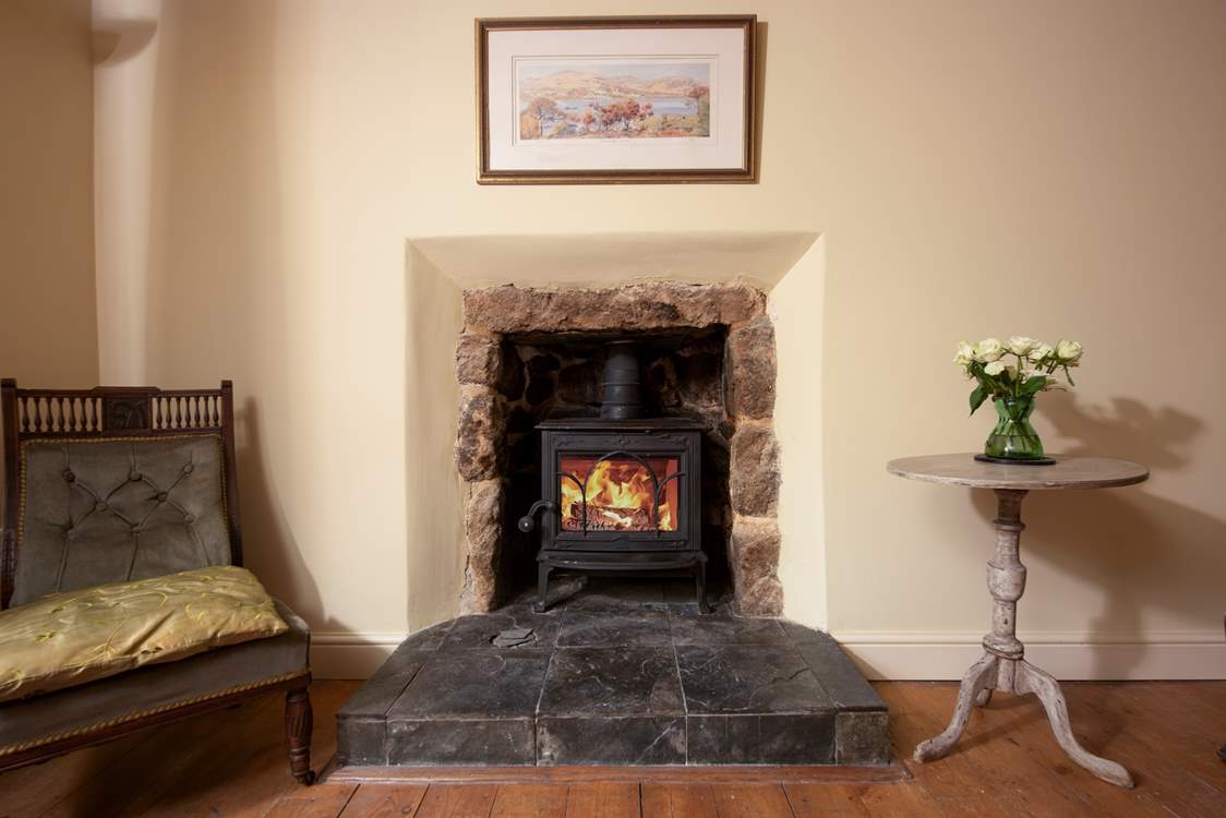 The sitting-room has retained its charm with a cosy wood-burner.