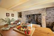 A warm and inviting dining-room, at the heart, this magnificent fireplace.