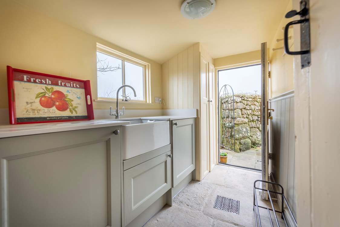 The side entrance of the house, is the main entrance and leads directly into a very useful utility-room.