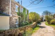 You will arrive to the back of the house and the entrance through the utility door which is by the yellow extension. Parking is on the lane opposite directly opposite the house. Take care as the approach to the cottage is single track.