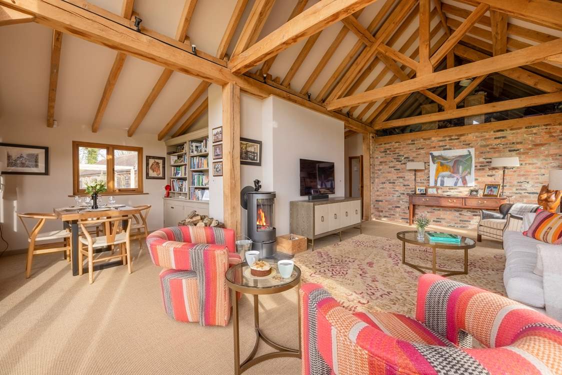The living area is so spacious with a vaulted ceiling and cosy wood-burner.
