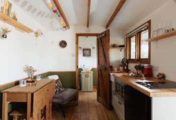 The light, airy space is filled with warm wooden accents and soothing splashes of sage green. 