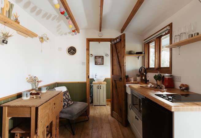 The light, airy space is filled with warm wooden accents and soothing splashes of sage green. 