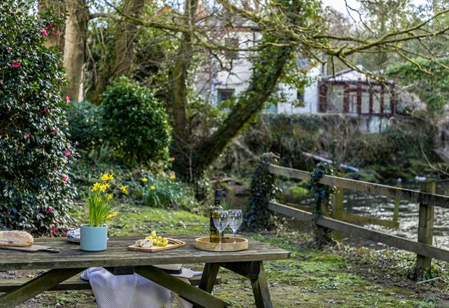 The main garden is set down by the river, accessed by the side of the garage. Please take care with young children,.