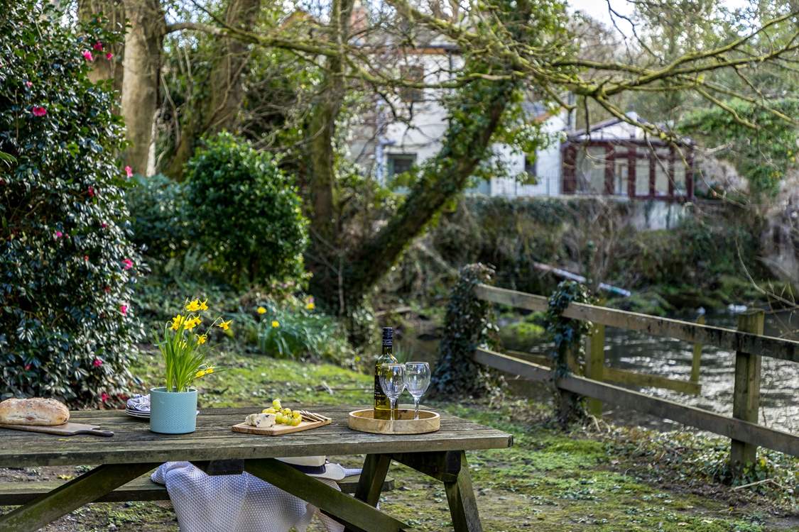 The main garden is set down by the river, accessed by the side of the garage. Please take care with young children,.