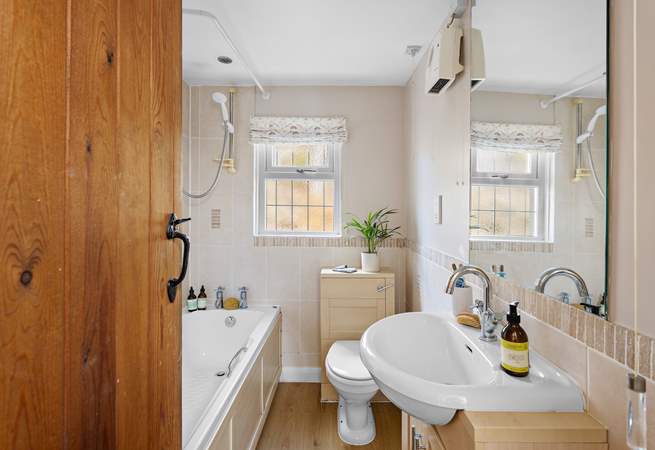 The family bathroom has a fitted shower over the bath.