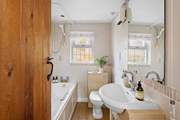 The family bathroom has a fitted shower over the bath.