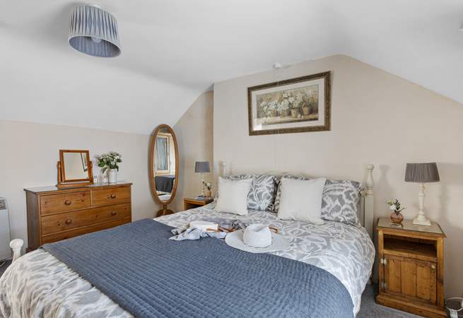 A comfy king-size bed awaits in bedroom 1.
