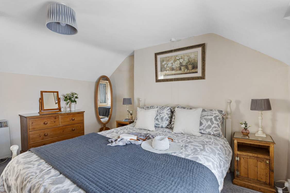 A comfy king-size bed awaits in bedroom 1.