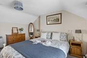 A comfy king-size bed awaits in bedroom 1.