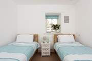 The twin room boasts fresh coastal hues.