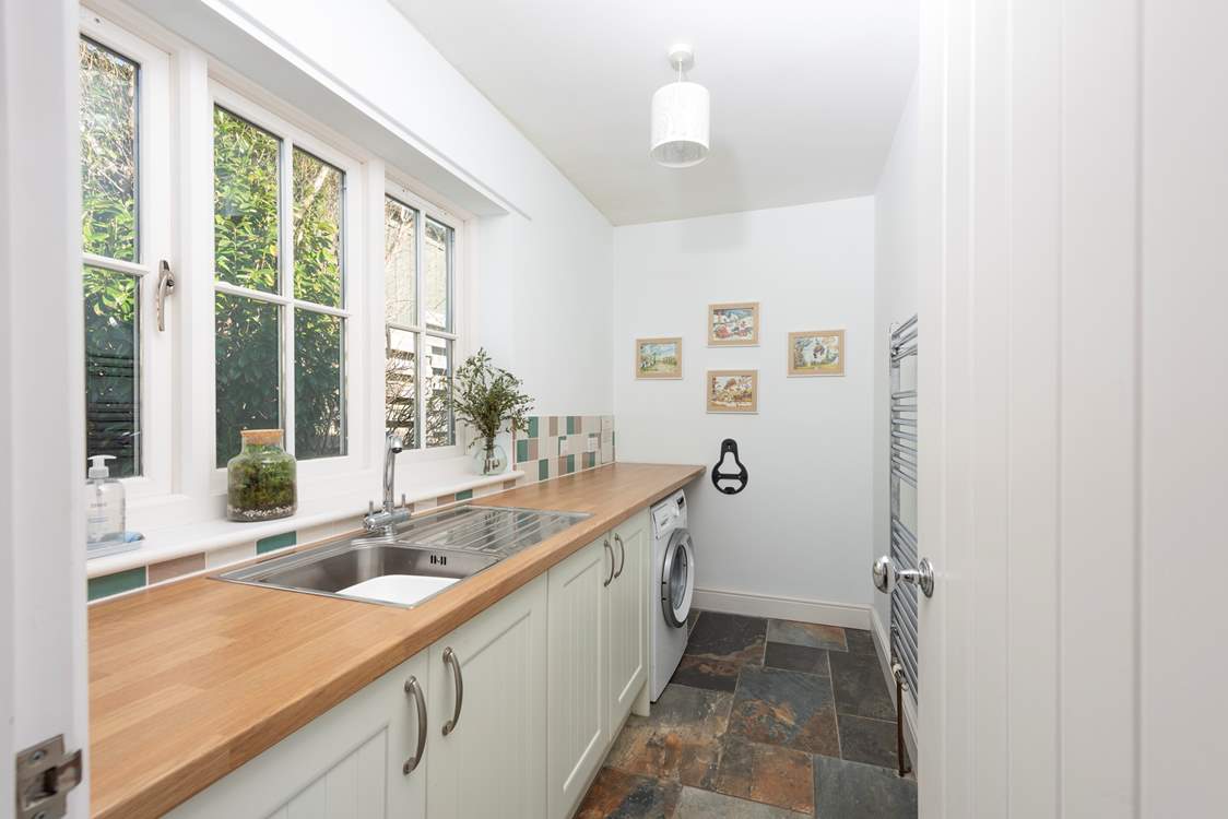 The handy utility-room has a sink, washing machine and heated towel rail.