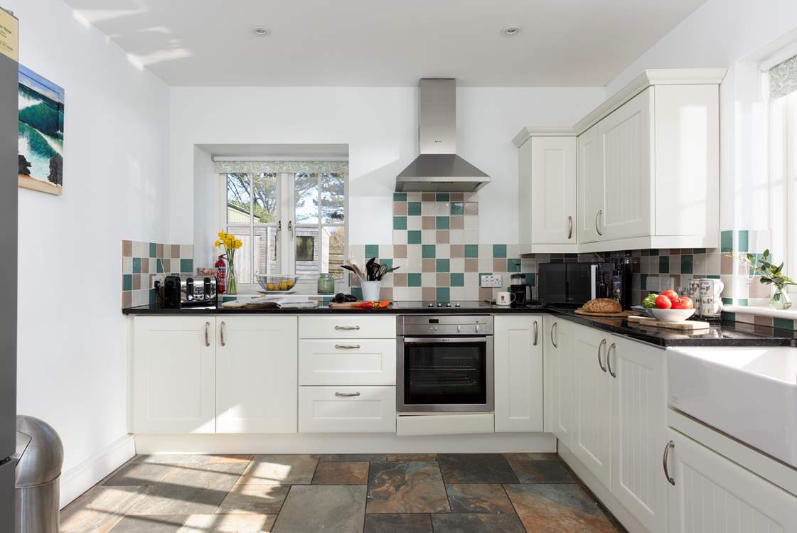 The well appointed kitchen looks out over the garden.