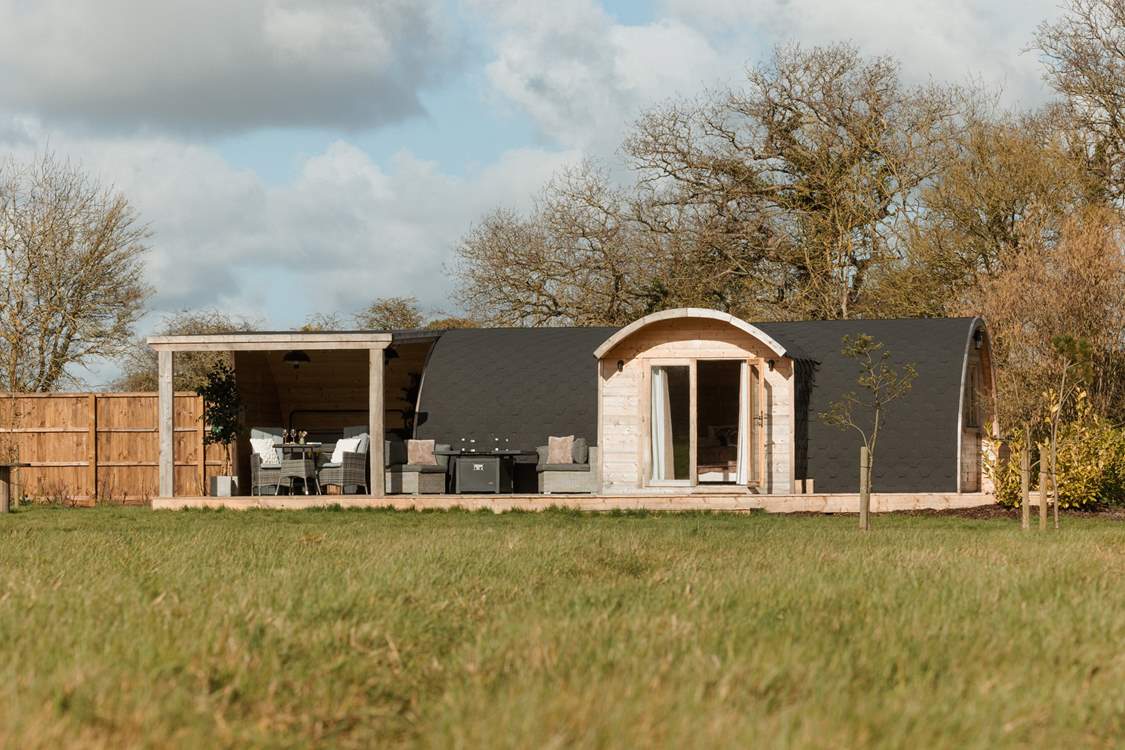 Perched in a verdant meadow this bespoke cabin offers an idyllic getaway.