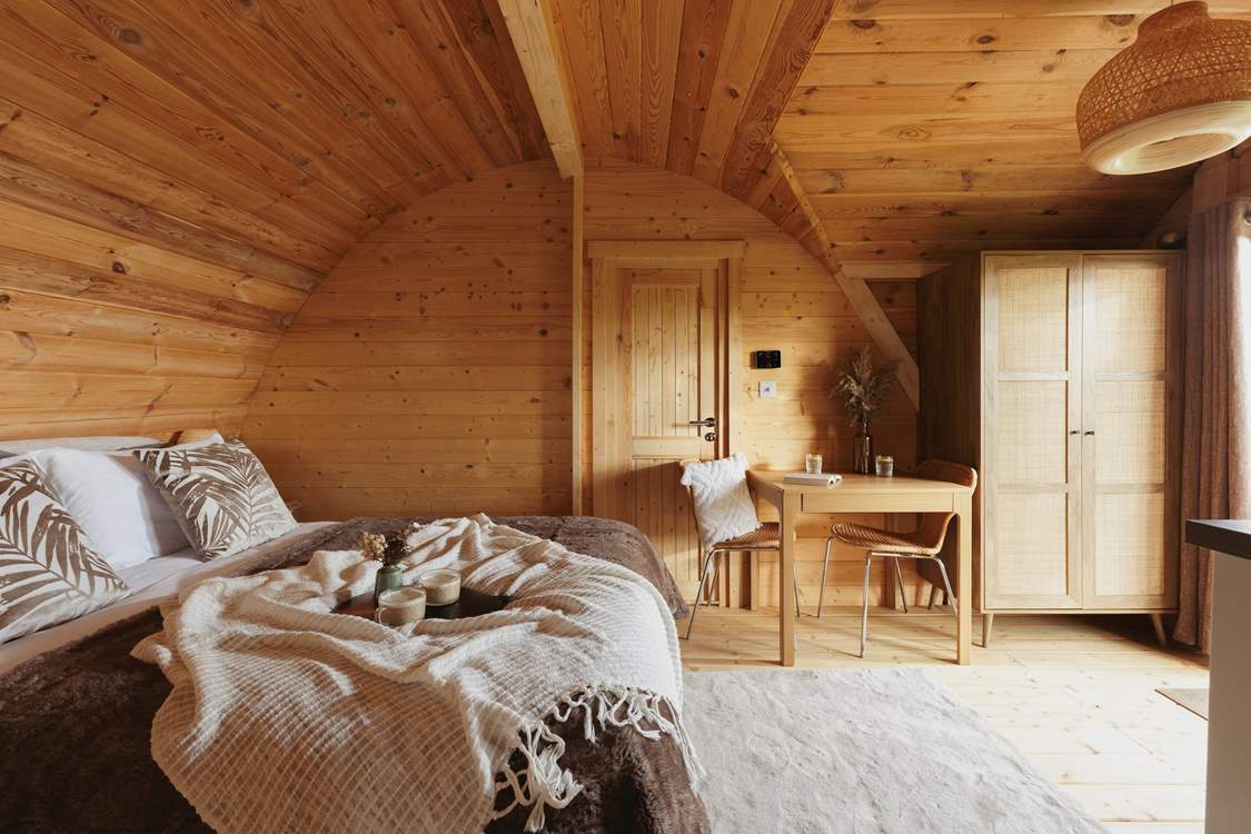 The sumptuous king-sized bed is dressed in luxury linens.