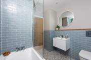 The family bathroom features stunning tiles.