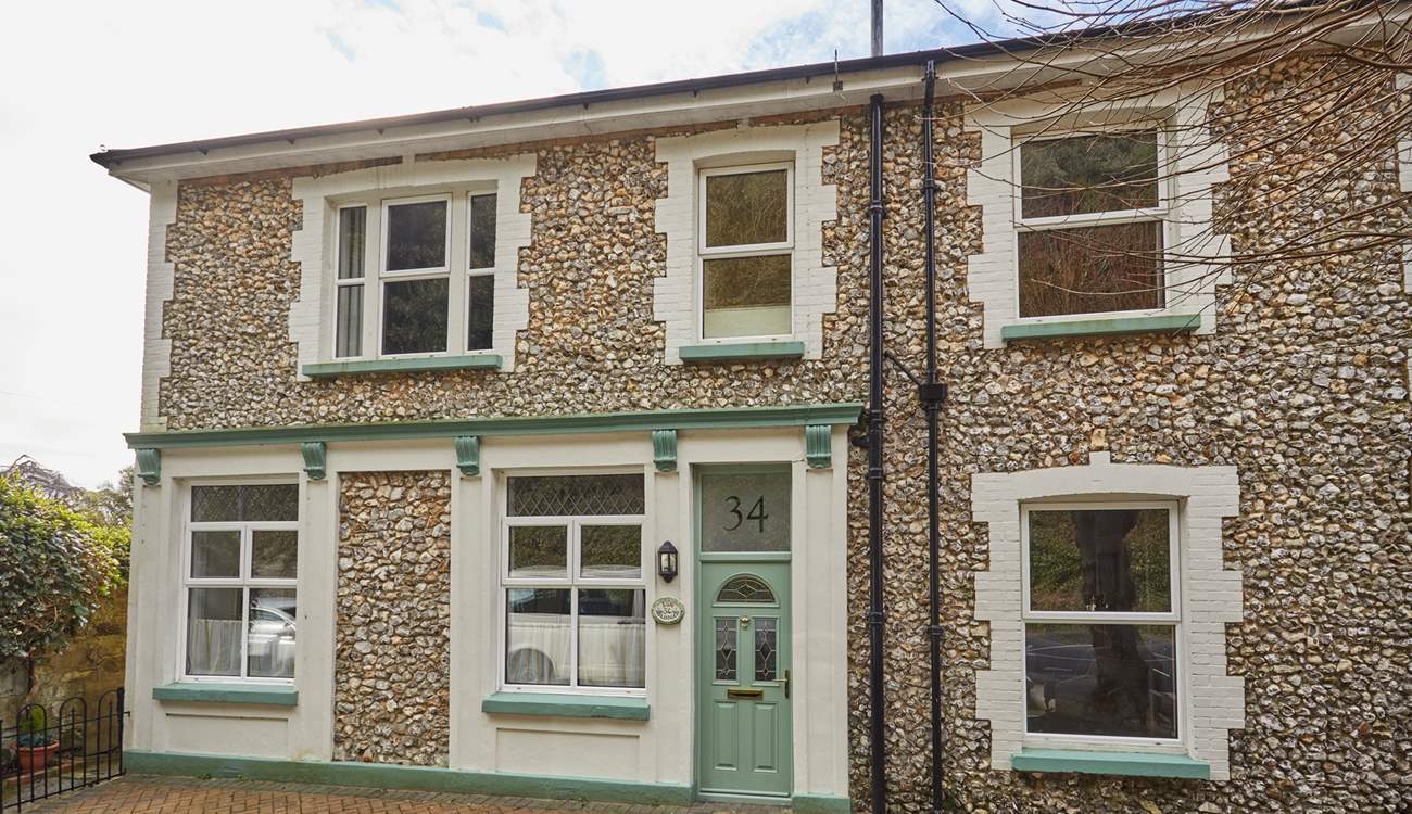 A unique stone facade and charming green door welcome you to Sun Lodge. 