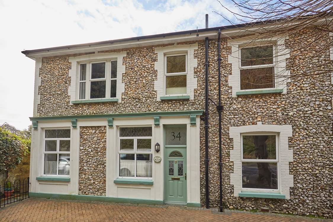 A unique stone facade and charming green door welcome you to Sun Lodge.