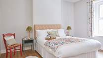 Imagine sinking into soft pillows and unwinding in this cosy bedroom. 