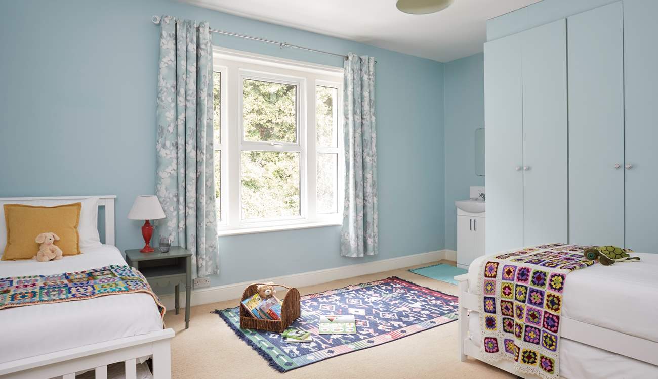 A comfortable space for rest and play in this spacious twin bedroom. 