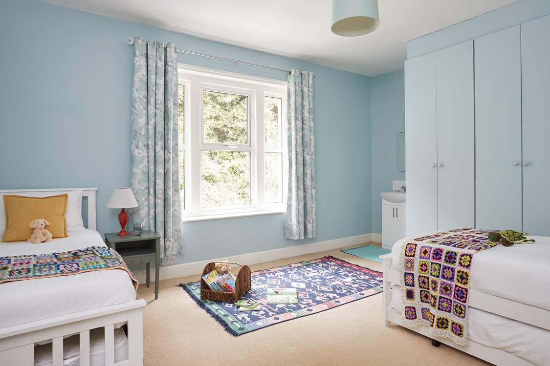 A comfortable space for rest and play in this spacious twin bedroom.