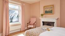 Serene slumber and glorious sea views await in this tranquil bedroom. 