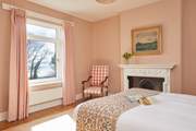 Serene slumber and glorious sea views await in this tranquil bedroom.
