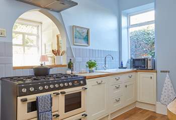 Classic cabinetry meets contemporary cool blue hues in the stylish kitchen. 