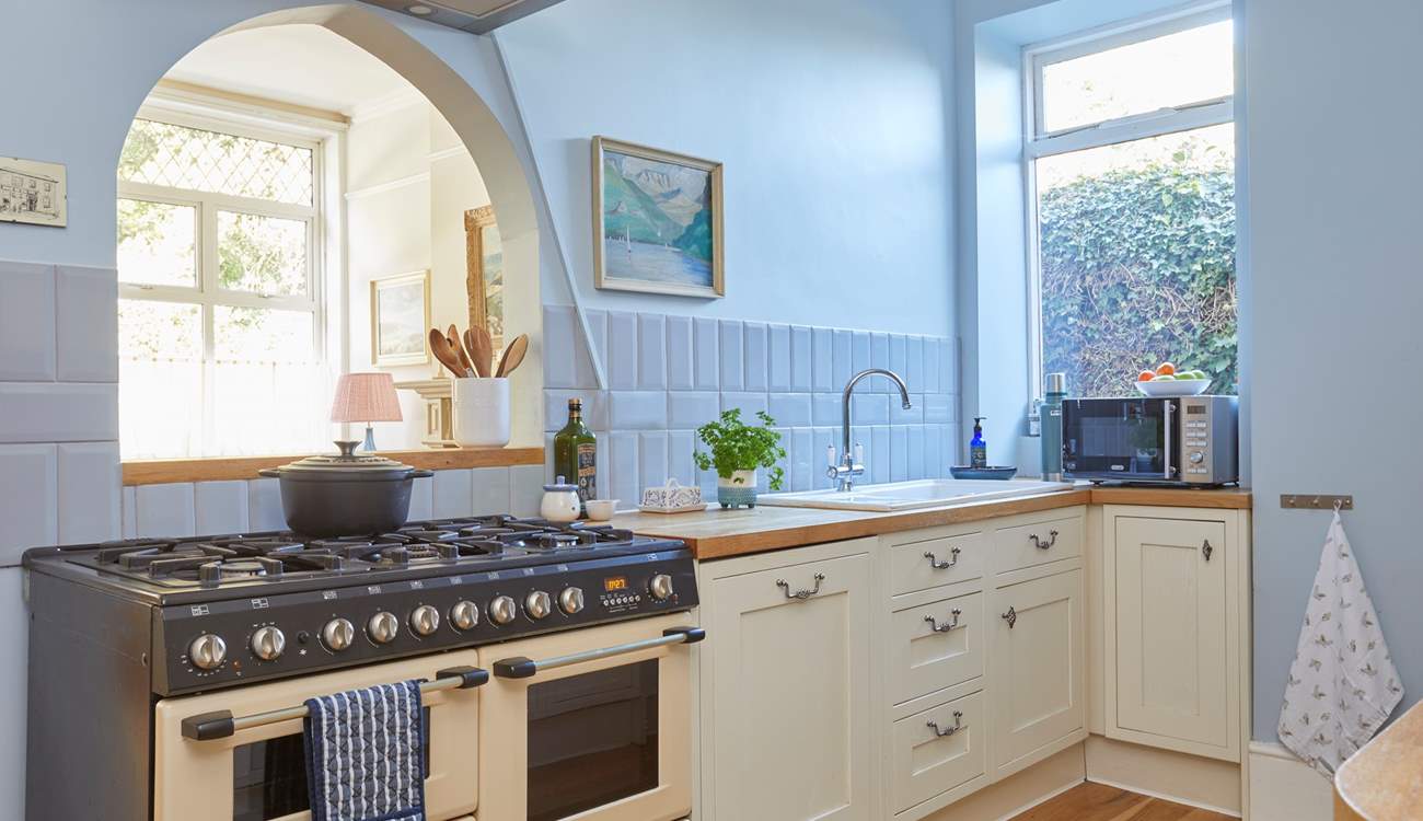 Classic cabinetry meets contemporary cool blue hues in the stylish kitchen. 