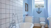 A soothing blue colour palette and nautical accents create this tranquil ground floor bathroom.