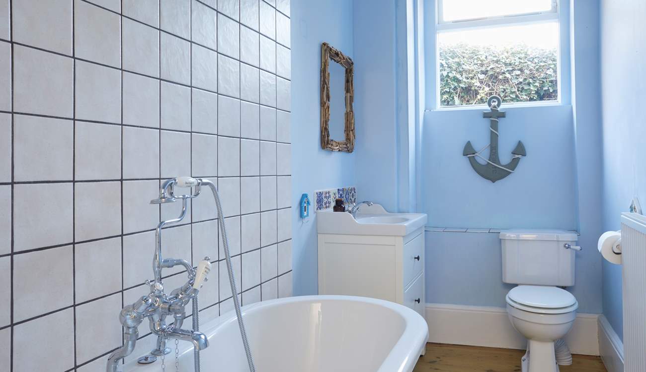A soothing blue colour palette and nautical accents create this tranquil ground floor bathroom.