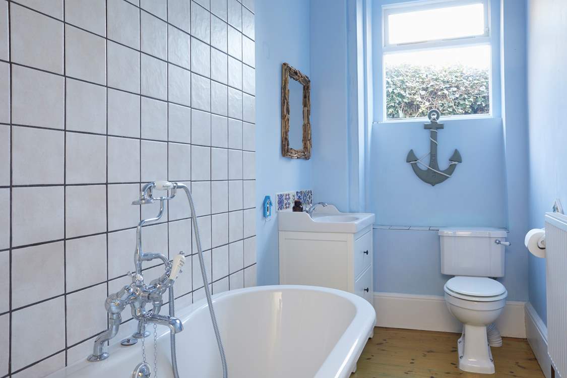 A soothing blue colour palette and nautical accents create this tranquil ground floor bathroom.
