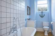 A soothing blue colour palette and nautical accents create this tranquil ground floor bathroom.