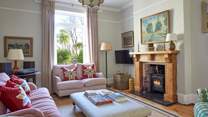 A cosy haven: the inviting sitting-room offers warmth and comfort with its fireplace and plush seating. 