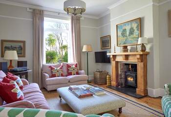 A cosy haven: the inviting sitting-room offers warmth and comfort with its fireplace and plush seating. 