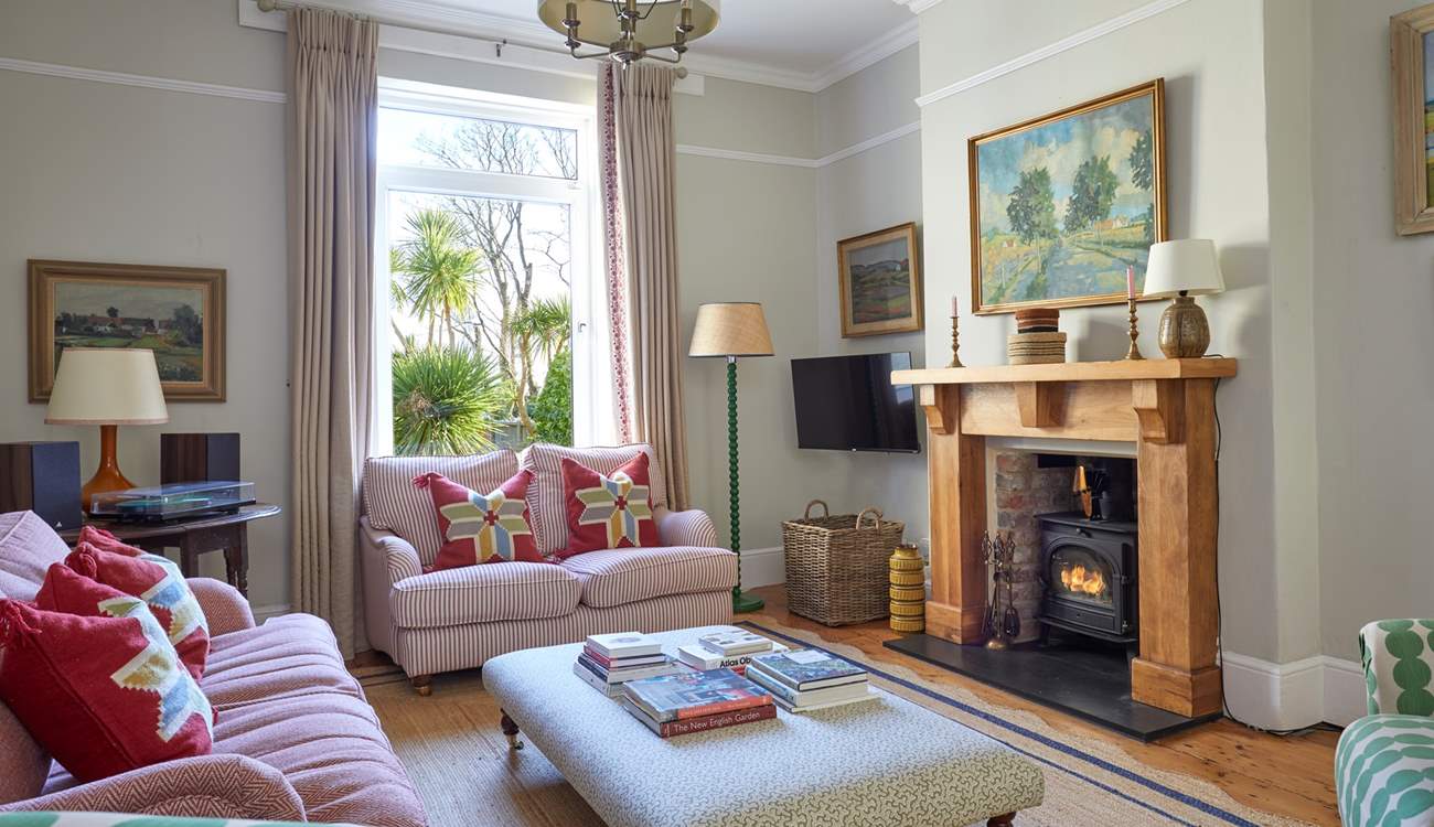 A cosy haven: the inviting sitting-room offers warmth and comfort with its fireplace and plush seating. 
