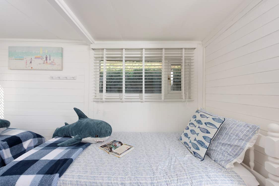The twin bedroom sits at the back of the cabin.