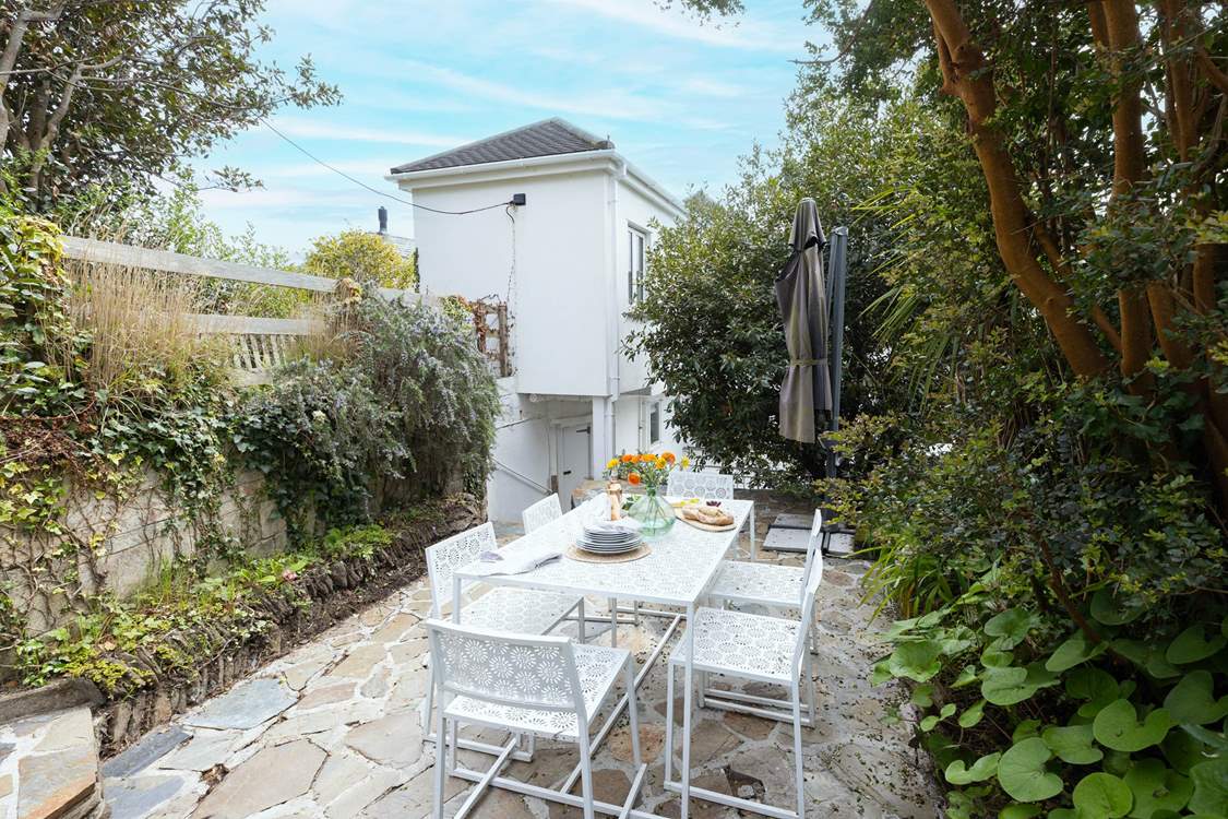 To the rear, accessed via steps, you will find two secluded patios for al fresco dining.