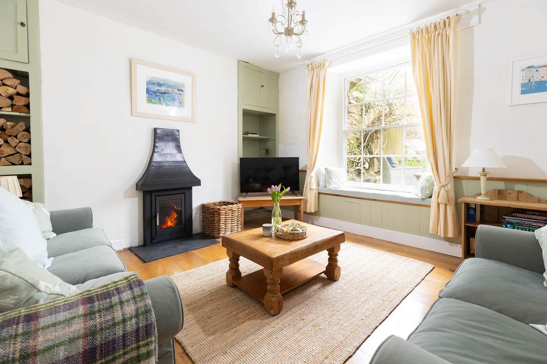 Coastal meets calm with earthy tones and a wood-burner.